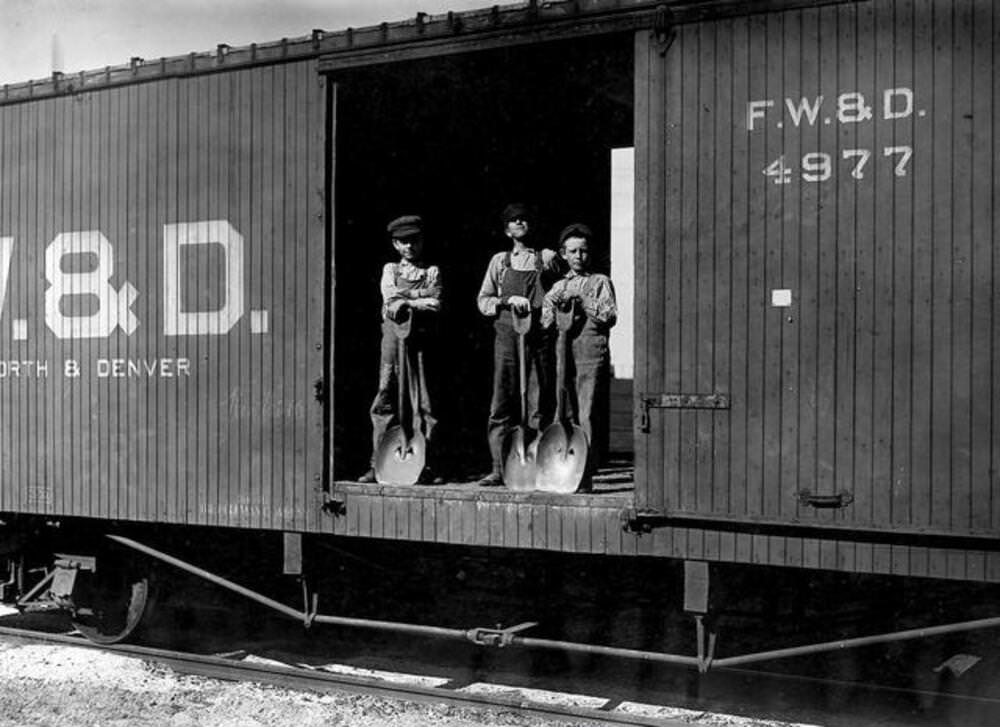 #16 Three young boys with shovels standing in doorway of a Fort Worth & Denver train car, 1912