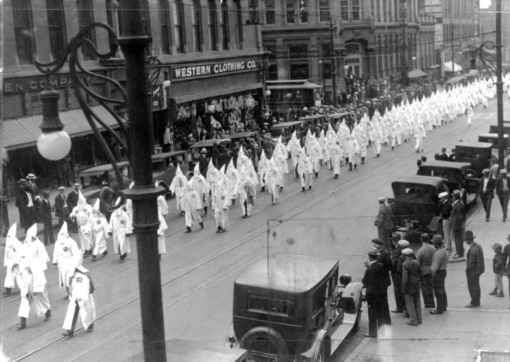#26 Members of the Ku Klux Klan march in a parade on Larimer Street in Denver, 1910s
