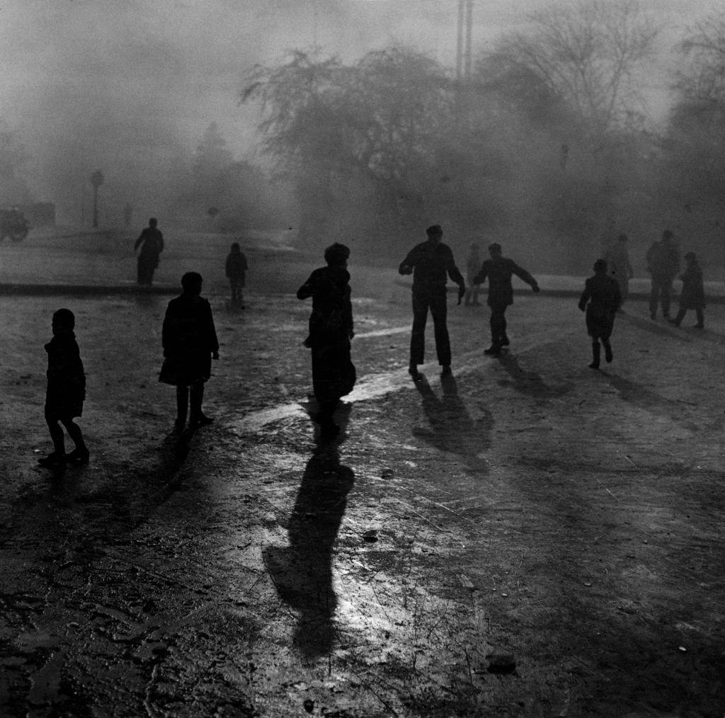 #6 Boys sliding on the ice in the fog at Hampstead Heath ponds during the Great Smog of London, 1952.