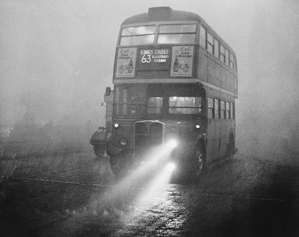 #25 A London double-decker bus, during the Great Smog of 1952.