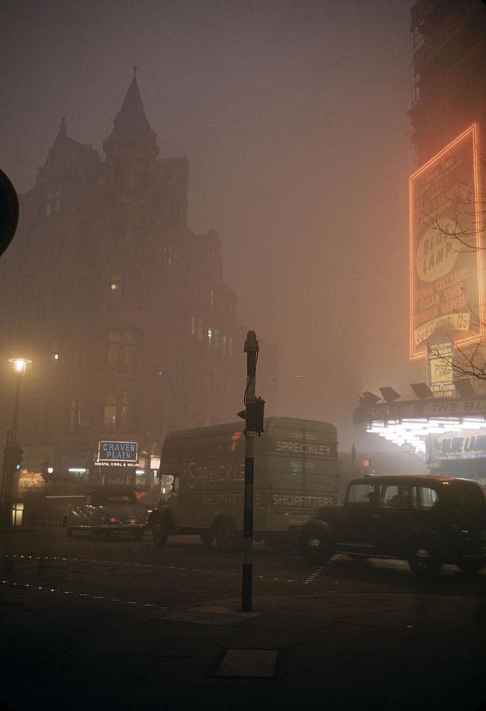 #8 Street scene on a foggy night near the Palace Theatre in Cambridge Circus, London, 1952.