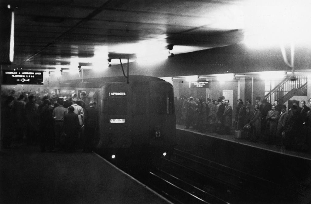#29 Large numbers of people using the underground system to get around London during a period of heavy smog, 8th December 1952.