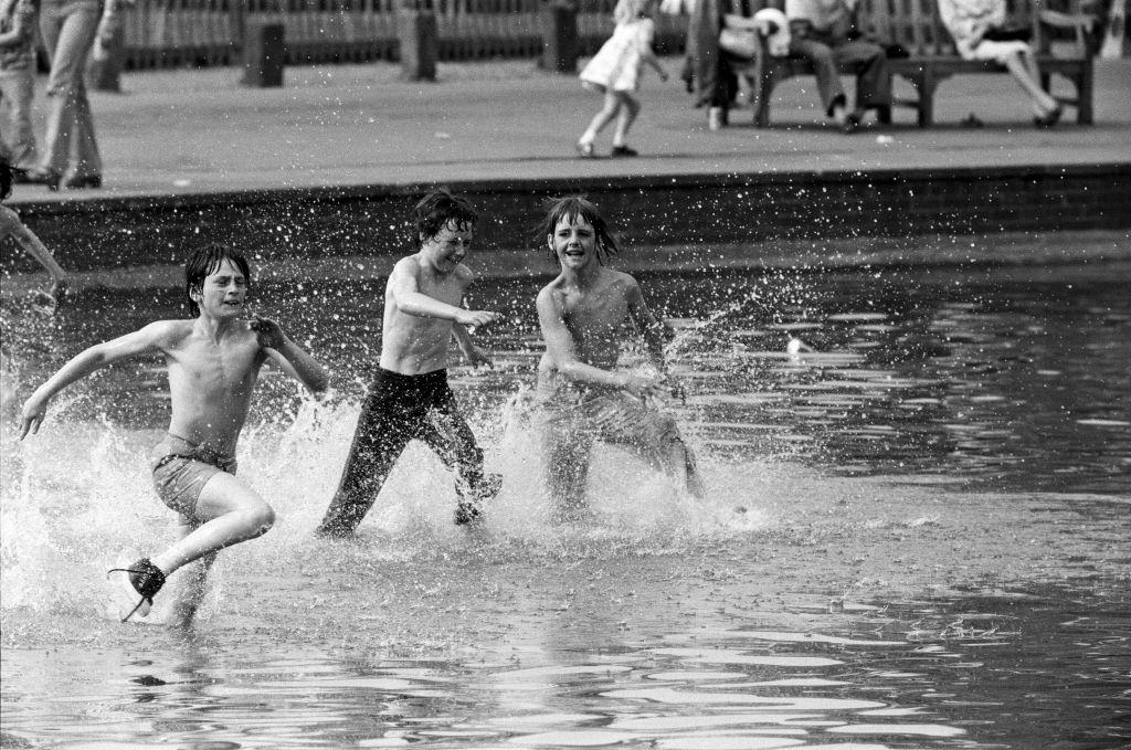 #35 Today’s sun brought out people onto Hampstead Heath to cool off in the water, 8th May 1976.