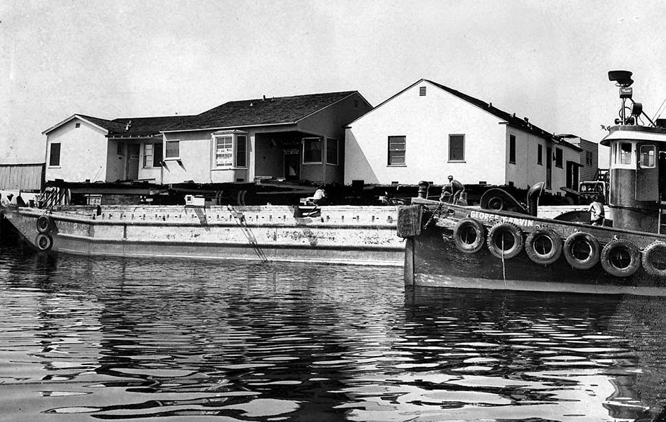 #11 A barge carrying a pair of houses is prepared to sail from Los Angeles Harbor to Port Hueneme in Ventura County. Aug. 23, 1960