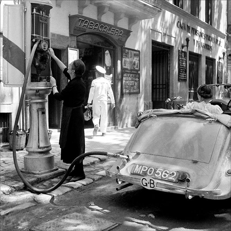 #14 Woman refilling at a petrol station, 1956