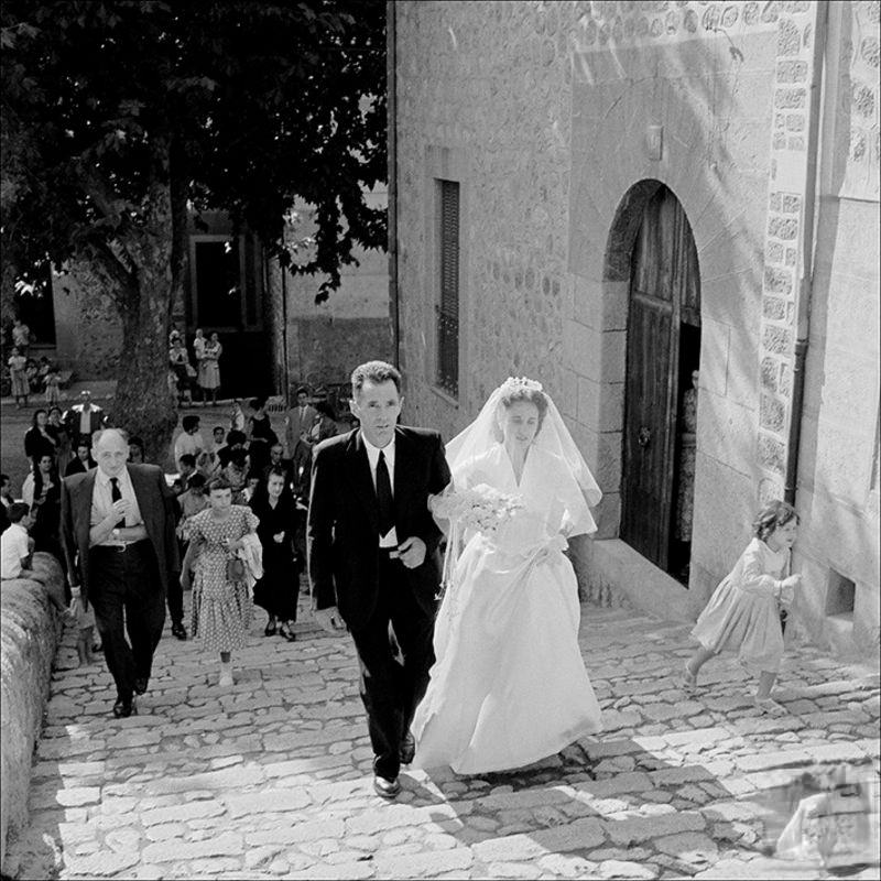 #31 Man accompanying a bride with people in the background, 1956
