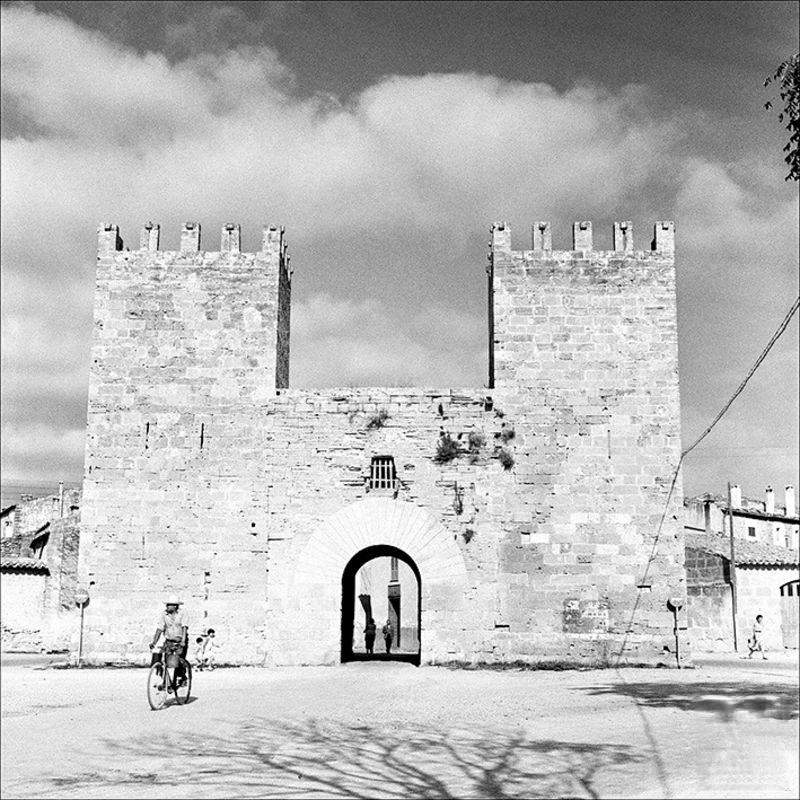 #50 Man with a bicycle at the door from the wharf of Alcúdia, 1956