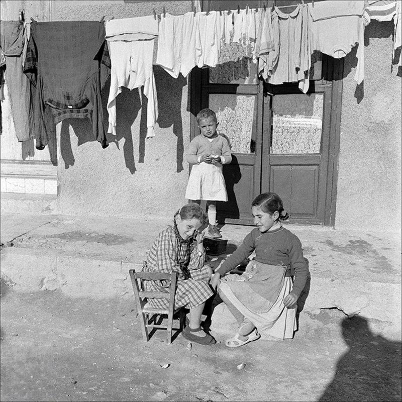#11 Children with clothes hanging in the background, 1956
