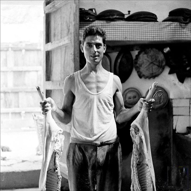 #12 Portrait of man with pig prepared to be cooked, 1956