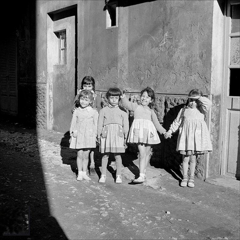 #29 Group of dolls on a street in Palma, 1956