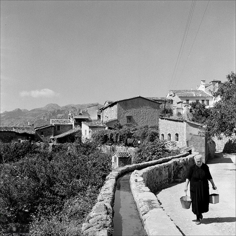 #9 Views of the town and woman walking next to a canal, 1957