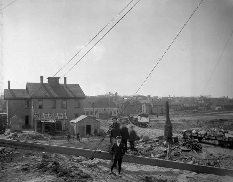 #25 Young boys in foreground posing for camera at Willis Point. Railroad in background, 1907