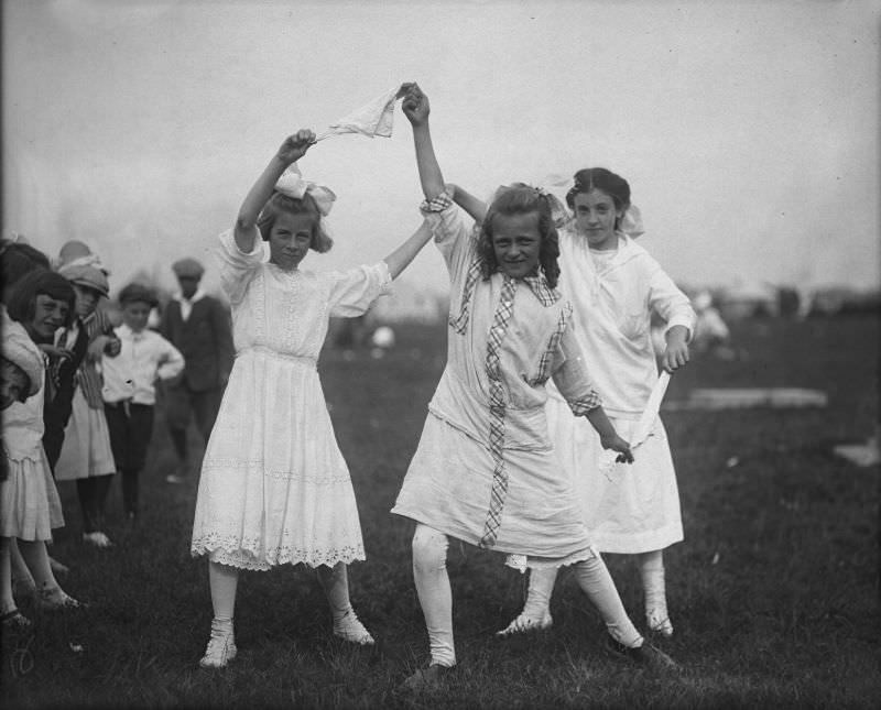 #27 Three girls with handkerchief at Buttonwood Park, playground outing, 1915