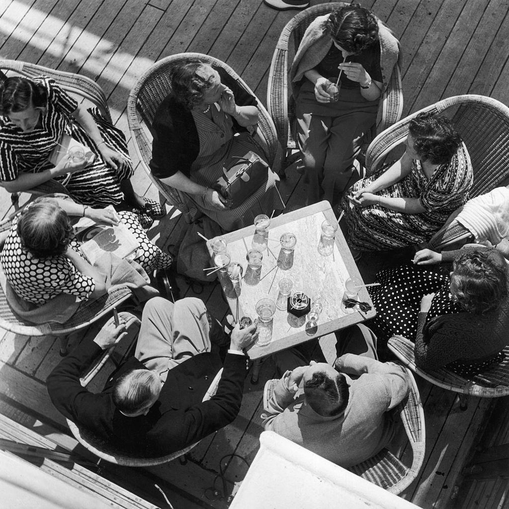 #33 Holidaymakers sip cocktails aboard the SS Chusan cruise liner off the coast of Norway, July 1951.