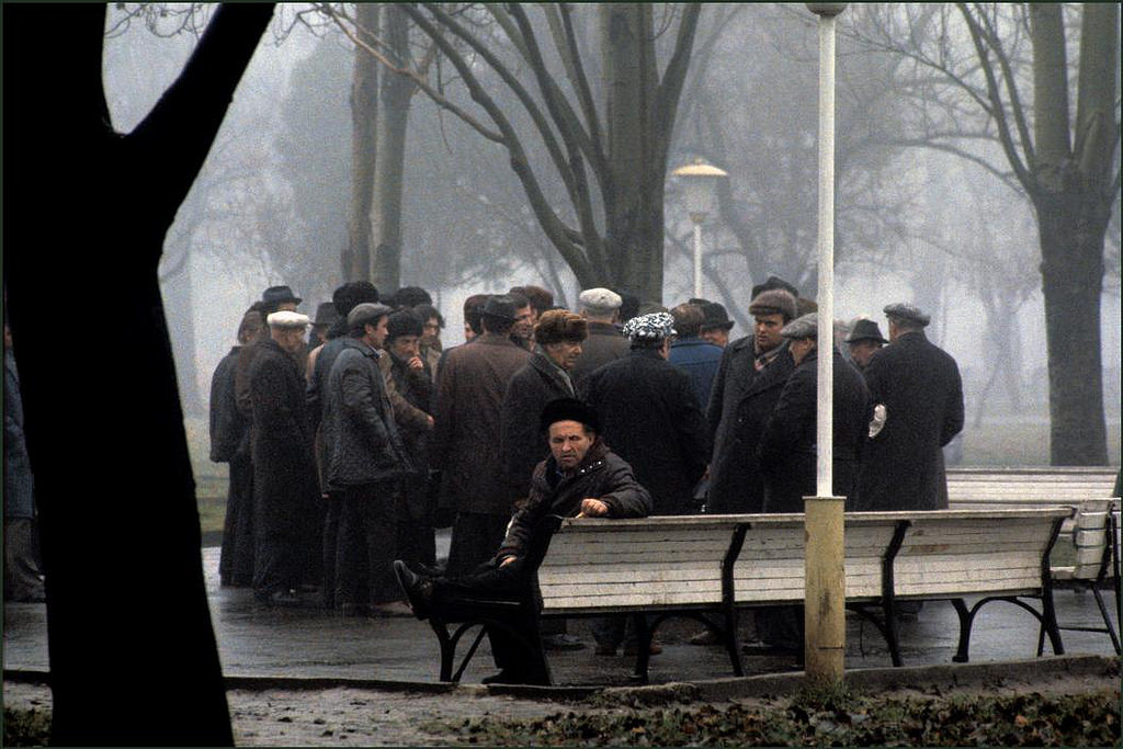 #20 Men gather to talk in the early morning mist and rain in the Shevchenko Park.