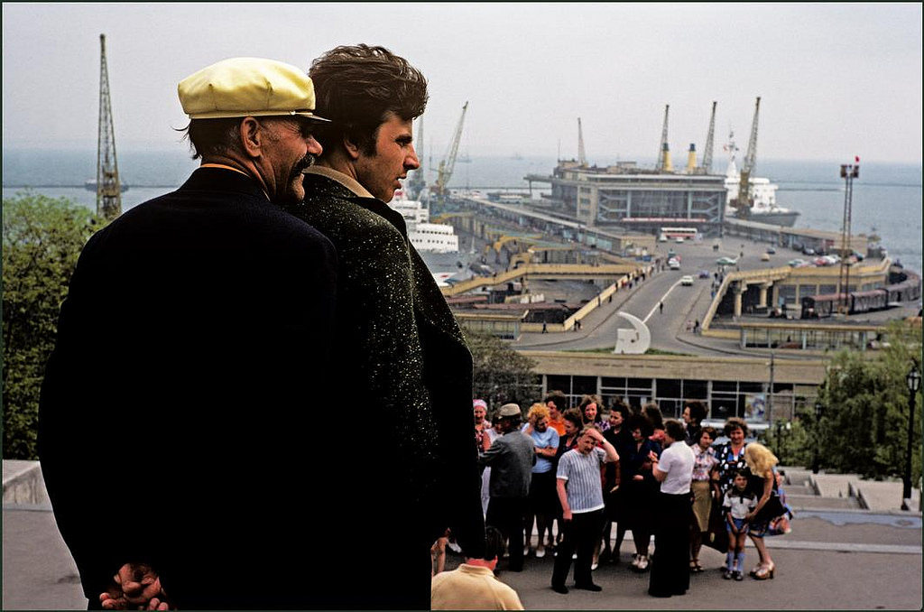 #13 Countryside visitors overlooking the famous Potemkin Steps and the port whilst the group has their photograph taken. Cranes, ships, train and offices in the background.