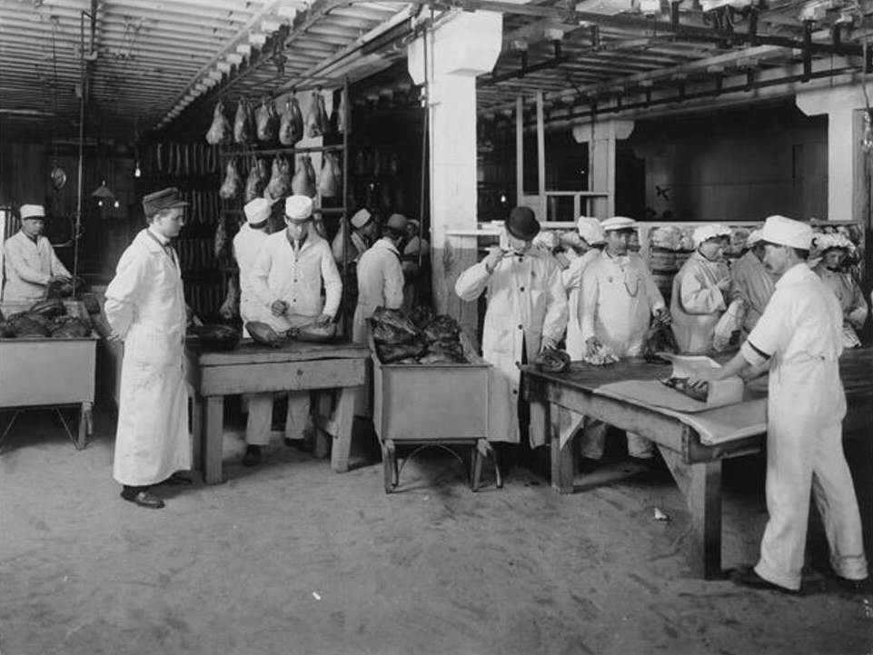 #17 Workers brand smoked hams in a meat packing establishment in South Omaha, Nebraska, 1910.