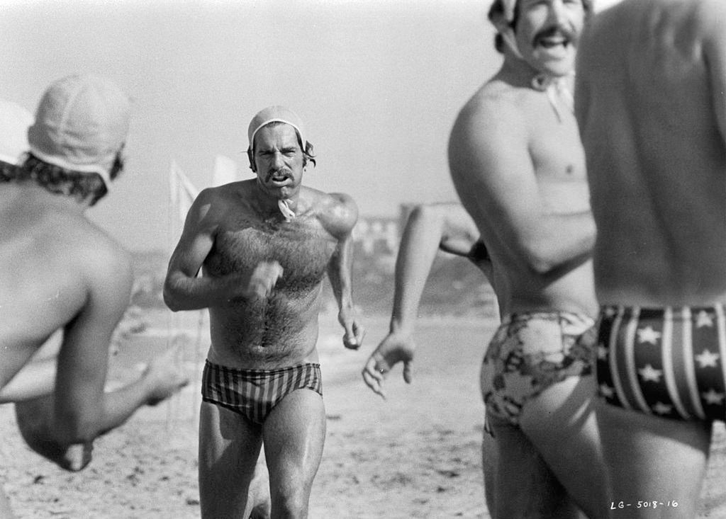 #8 Sam Elliott running on beach in a scene from the film ‘Lifeguard’, 1976.