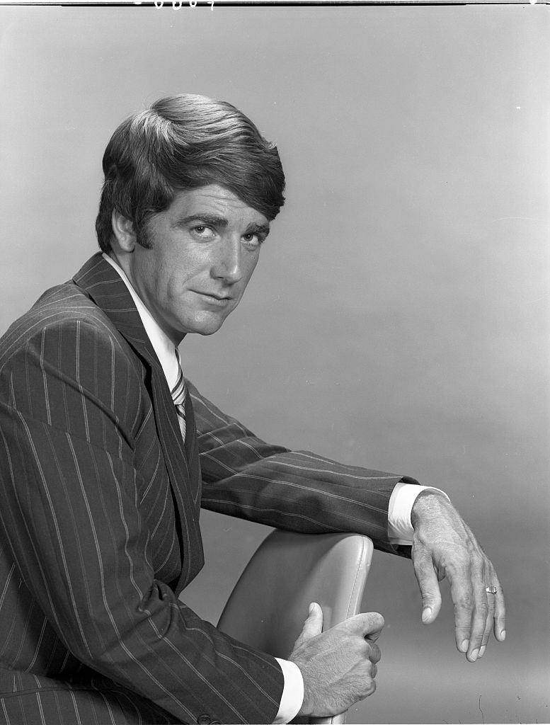 #16 Sam Elliot posing while sitting on a chair, 1971.