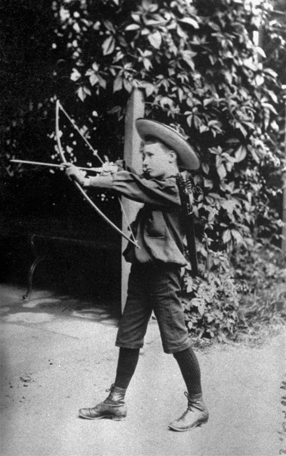 #3 Franklin Delano Roosevelt playing with a bow and arrow circa 1890.