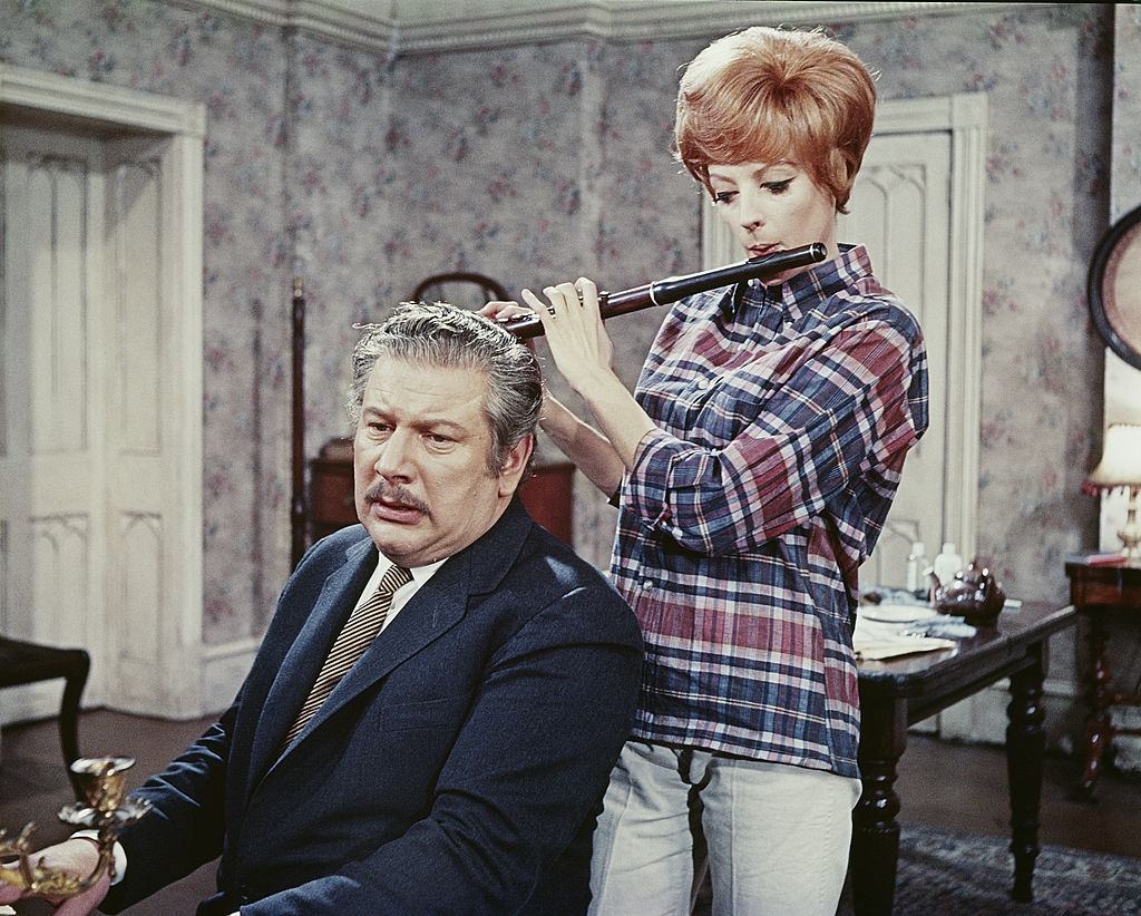 #26 Maggie Smith plays the flute in this scene from the movie “Hot Millions”, 1968.