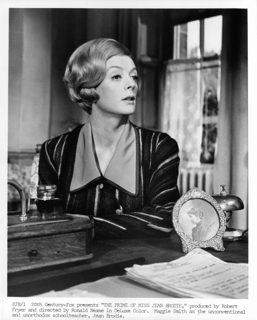 #29 Maggie Smith looking from her desk in a scene from the film ‘The Prime Of Miss Jean Brodie’, 1969.