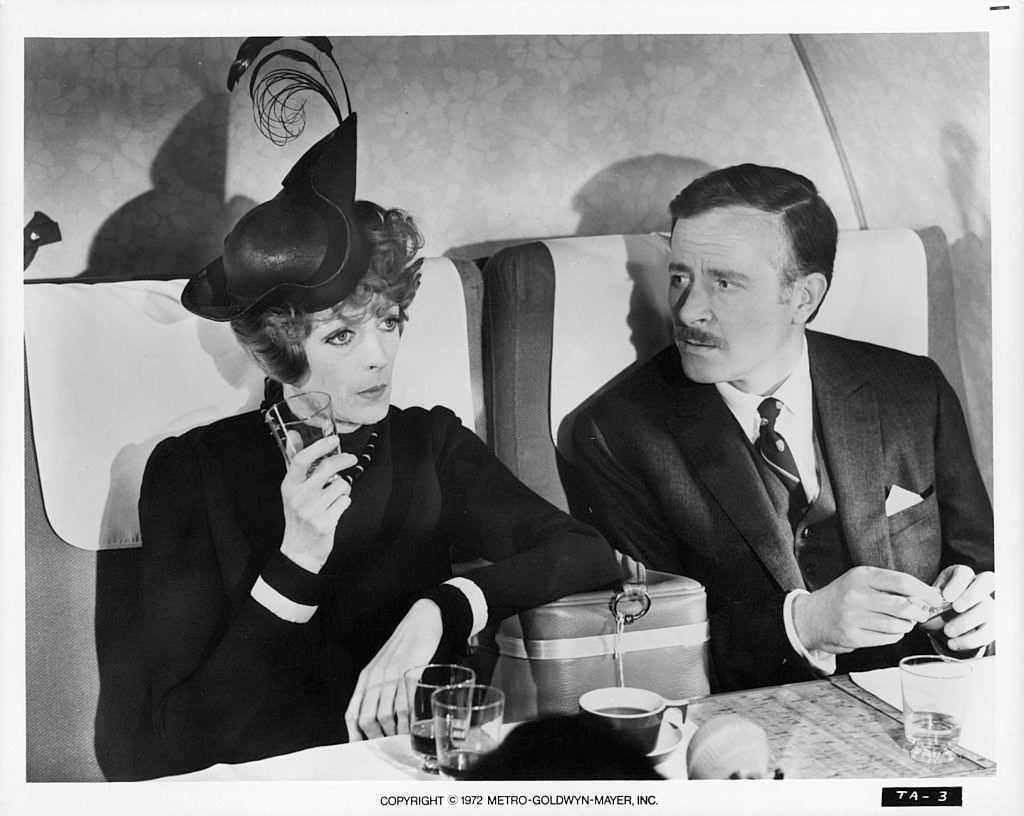 #40 Maggie Smith with Alec McCowen sitting on plane together in a scene from the film ‘Travels With My Aunt’, 1972.