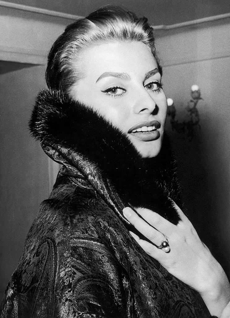 #60 Sophia Loren, wearing a coat, 1956.