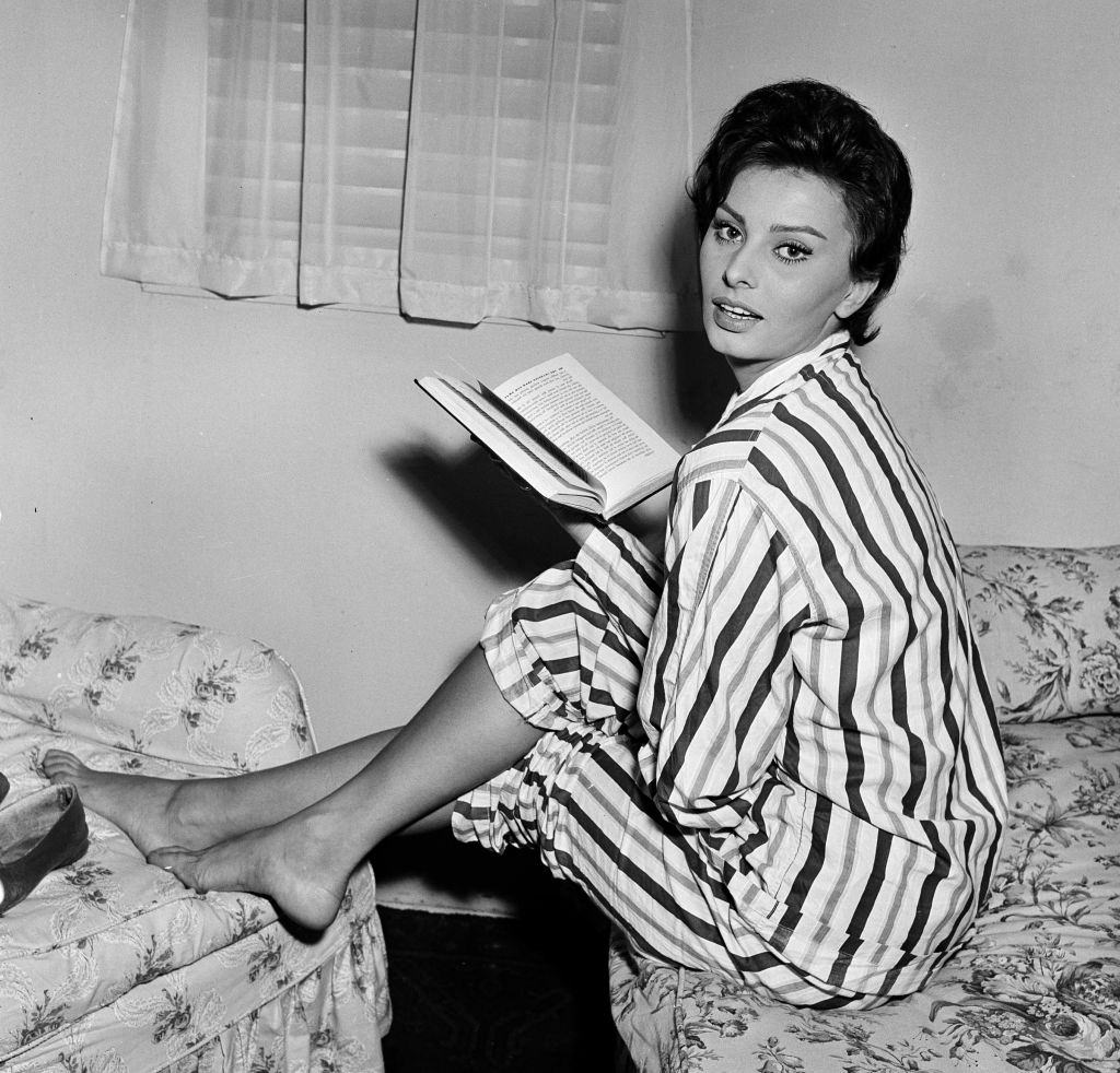 #65 Sophia Loren reading a book while making the film “The Key” at Elstree Studio’s, 1957.