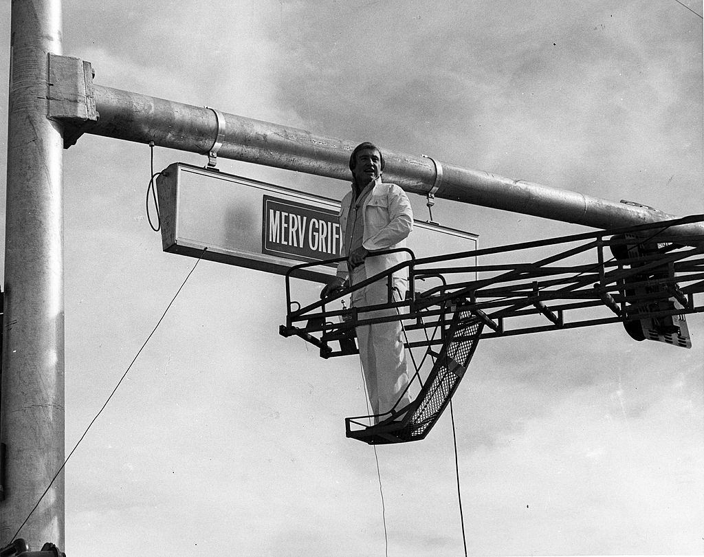 #70 Talk show host Merv Griffin showcasing Merv Griffin Blvd in Las Vegas, 1975.