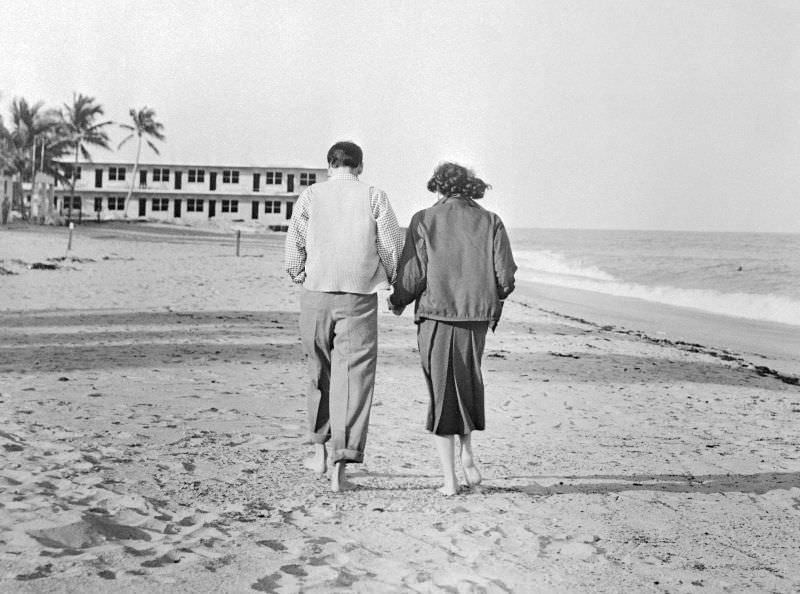 #24 Frank Sinatra and Ava Gardner strolling along a beach in Miami, two days after tying the knot, 1951.