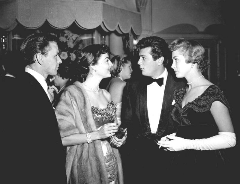 #26 Frank Sinatra and Ava Gardner with Tony Curtis and Janet Leigh attend a dinner at the Empress Club, London, 1951.