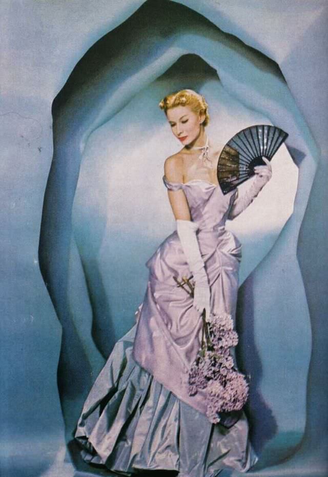 #12 Lisa Fonssagrives poses in a luxurious two-tone taffeta gown by Charles James