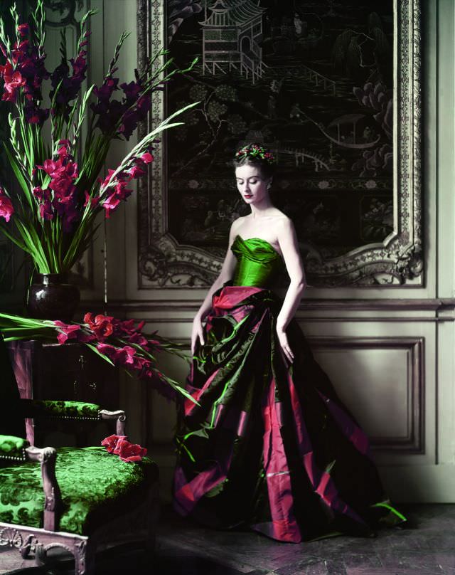 #16 Model Gigi in an evening gown of voluminous plaid taffeta skirt and and green taffeta bustier by Pierre Balmain