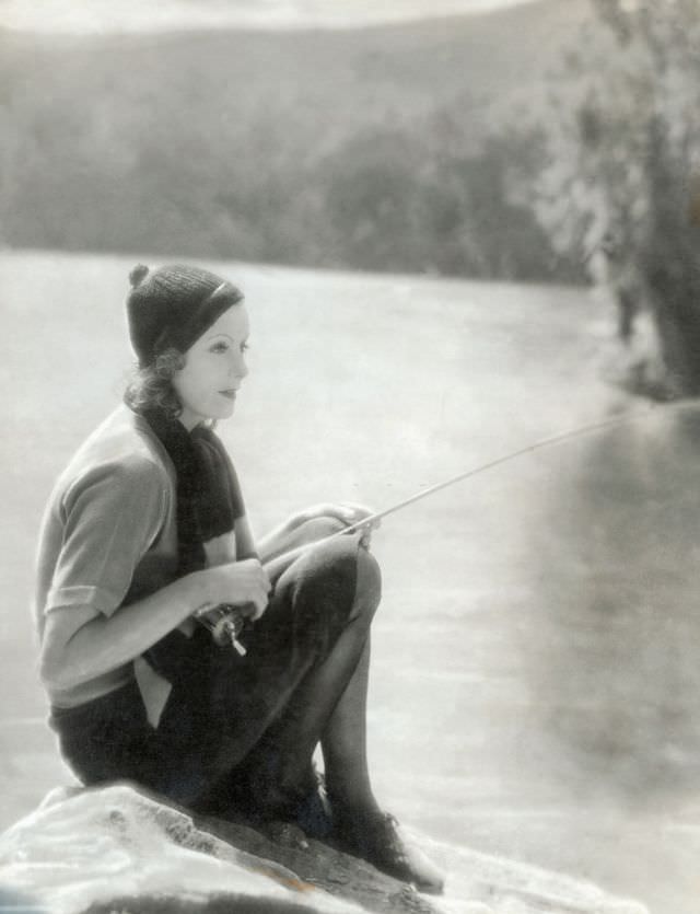 #41 Greta Garbo posing with fishing rod in the outdoors, 1929.