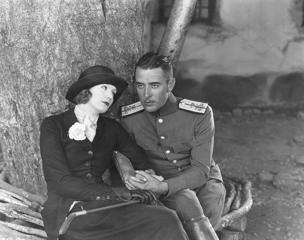 #70 Greta Garbo with actor John Gilbert on the set of “Love”.