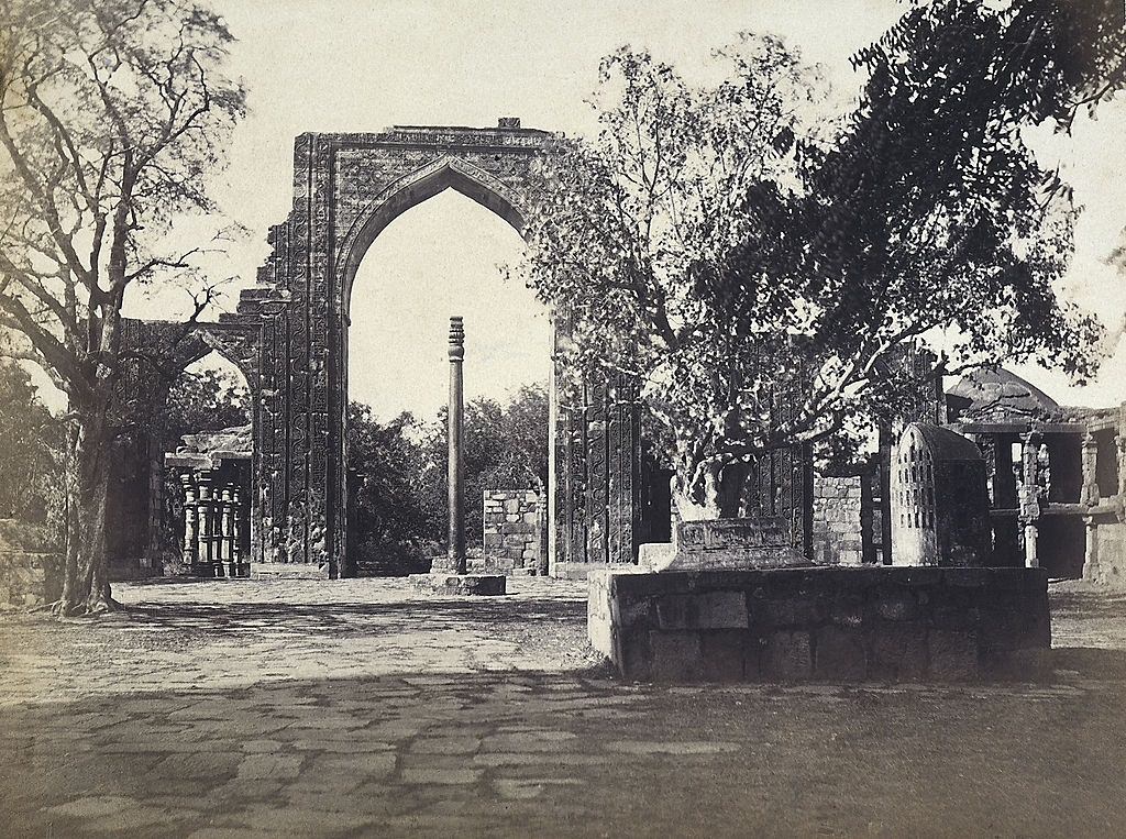 #26 The iron pillar and the great arch of the mosque built by Kutubuddin, near the Qutub Minar, in Delhi, 1870s.