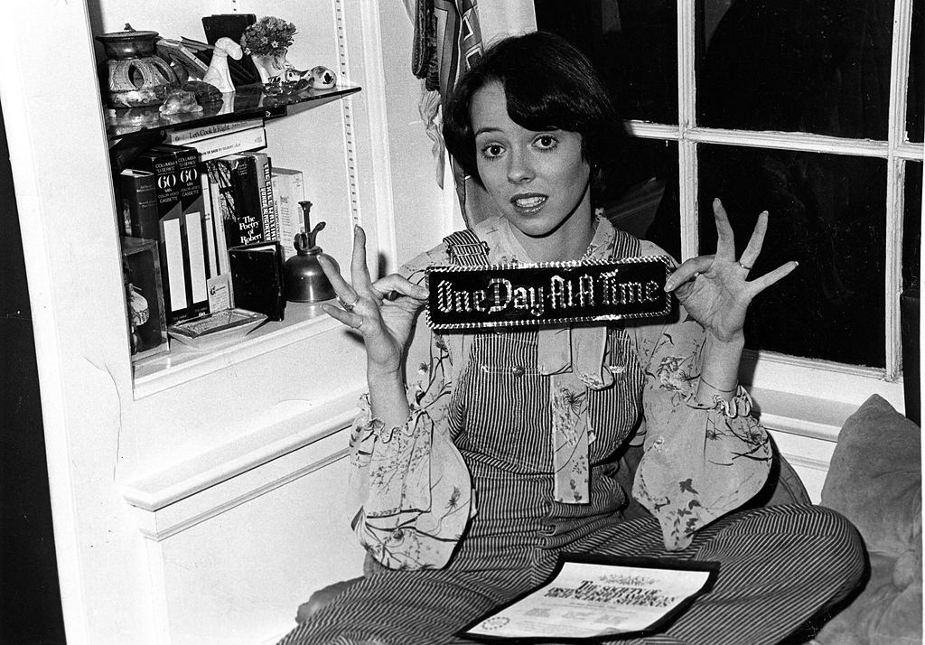 #20 Mackenzie Phillips olding a bumper sticker that reads “One Day At A Time” on December 3, 1976