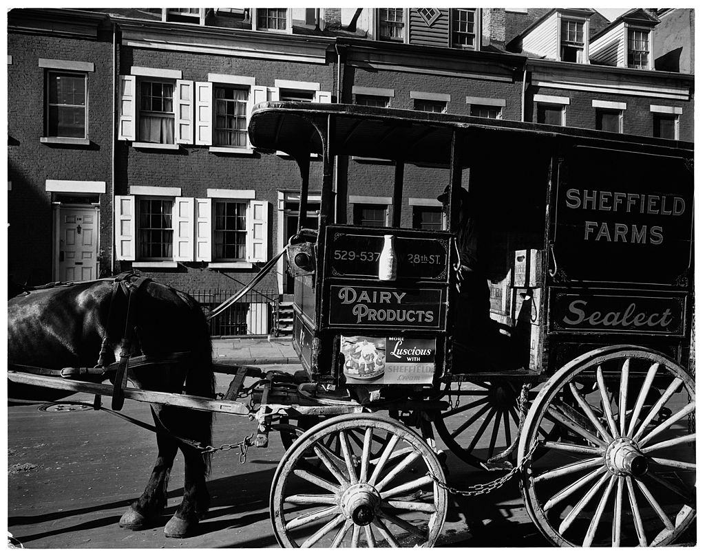 #62 A milkwagon and old houses, New York City, 1936.