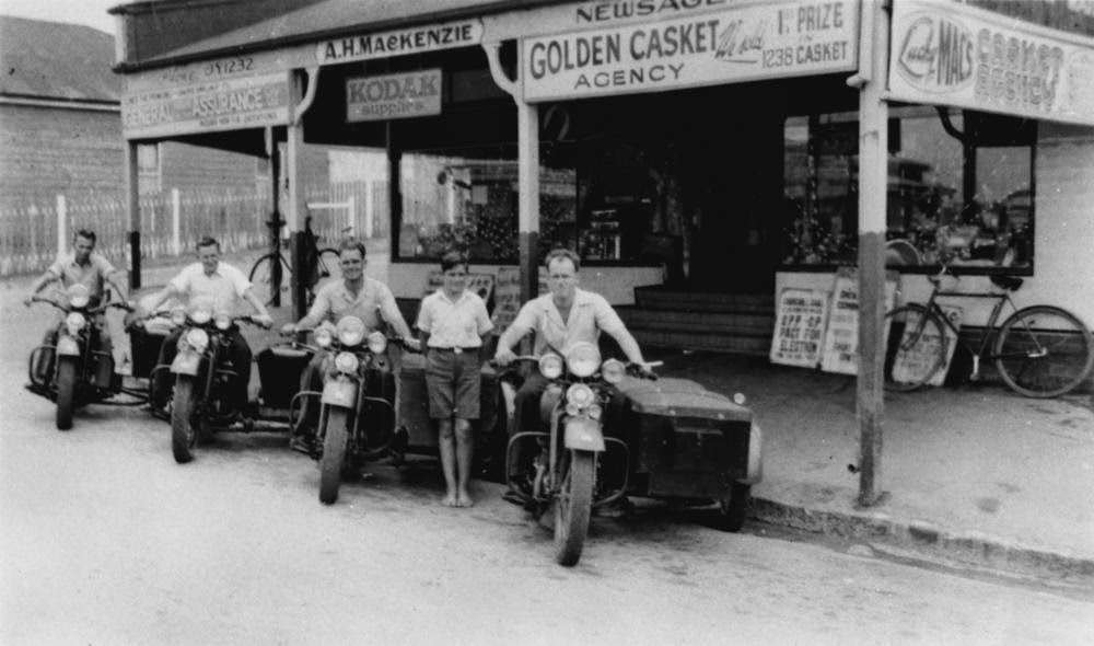 #61 Harley Davidson motorbikes with sidecars outside Mackenzie’s Newsagency, Bulimba, Brisbane, 1953