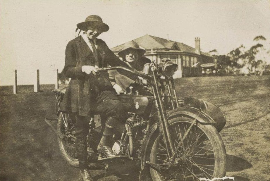 #70 Two women posing with a motorbike and sidecar, 1922.