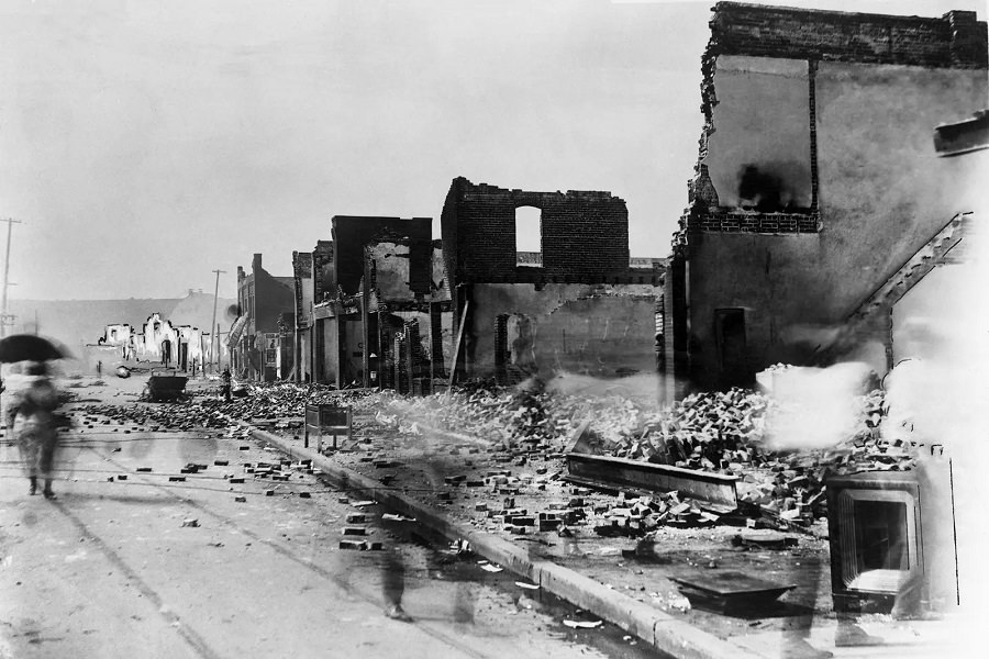 #13 This photo shows the aftermath of the massacre at the east corner of Greenwood Avenue and East Archer Street in June 1921.