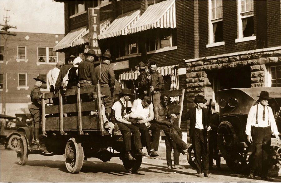 #14 Injured and wounded men are taken to the hospital by National Guard troops on June 3, 1921.