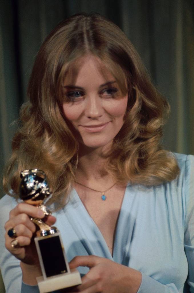 #28 Cybill Shepherd holds a Golden Globe Award in 1973.