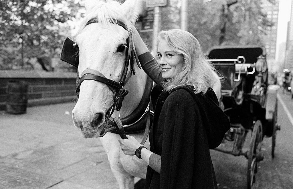 #7 Cybill Shepherd posing with a horse, 1983.