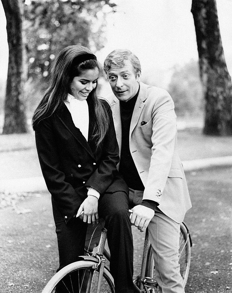 #17 Michael Caine with model Bianca De Macias, 1964.