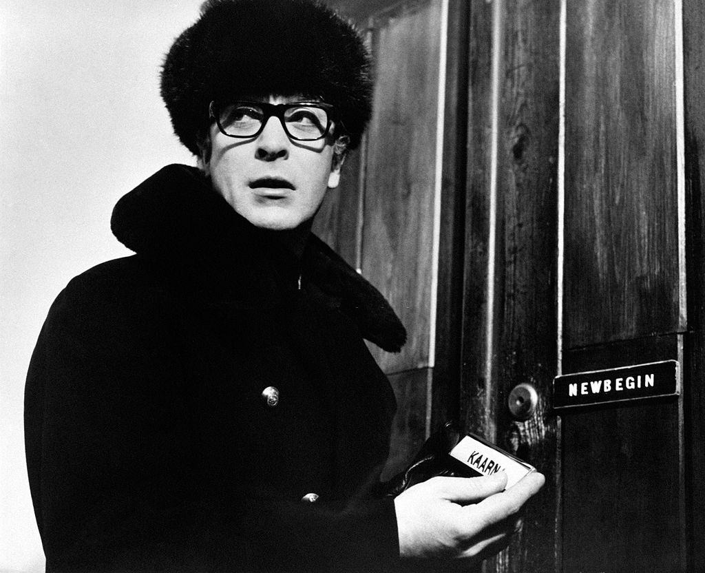 #6 Michael Caine in front of a door with a plate in the hand in the film Billion Dollar Brain, 1967.
