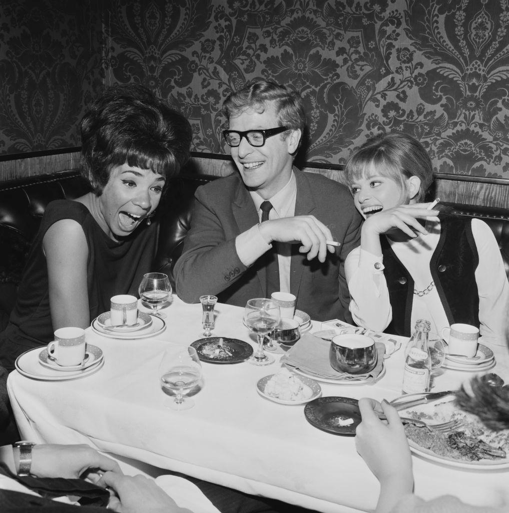 #22 Michael Caine with Welsh singer Shirley Bassey and fashion designer Edina Ronay, 1964.