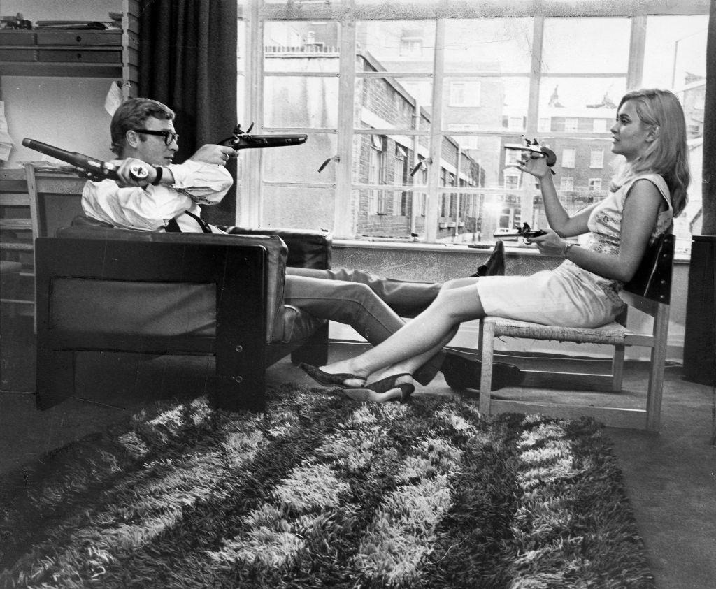 #35 Michael Caine with Alexandra Bastedo, May 1965.
