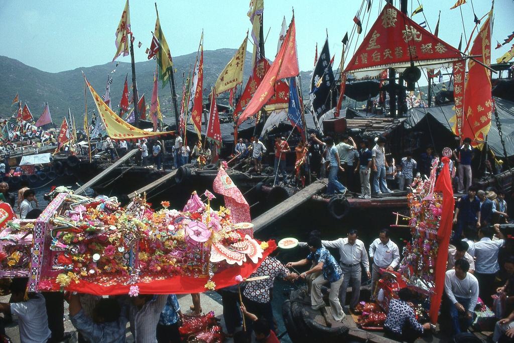 #2 Celebrants carry paper shrines from boats to temple on Po Toi Island during festival dedicated to Goddess of Sailors and the Sea. Hong Kong, 1980s.